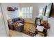 This living room features a cozy couch, a large rug, and a window with shutters at 26166 Stillwater Cir, Punta Gorda, FL 33955