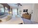 Bright main bedroom with a king-size bed, ceiling fan, and access to ensuite bathroom at 26166 Stillwater Cir, Punta Gorda, FL 33955