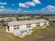 An aerial view of a condo community showcasing a building with a pool and patio area at 26397 Nadir Rd # 208, Punta Gorda, FL 33983