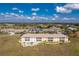 Aerial view of a community featuring a building with pool and surrounding landscape at 26397 Nadir Rd # 208, Punta Gorda, FL 33983
