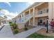 Exterior view of condo building with parking and landscaping at 26397 Nadir Rd # 208, Punta Gorda, FL 33983