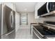 Modern kitchen with stainless steel appliances and white cabinets at 26397 Nadir Rd # 208, Punta Gorda, FL 33983