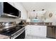 Modern kitchen with stainless steel appliances and white cabinets at 26397 Nadir Rd # 208, Punta Gorda, FL 33983
