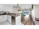 Open kitchen with stainless steel appliances and white cabinets at 26397 Nadir Rd # 208, Punta Gorda, FL 33983