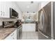 Modern kitchen with stainless steel appliances and white cabinets at 26397 Nadir Rd # 208, Punta Gorda, FL 33983