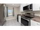 Well-equipped kitchen with stainless steel appliances and white cabinets at 26397 Nadir Rd # 208, Punta Gorda, FL 33983