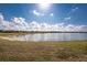 Scenic lake view with lush green grass at 26397 Nadir Rd # 208, Punta Gorda, FL 33983