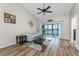 Condo living room with lake view, comfy seating, and hardwood floors at 26397 Nadir Rd # 208, Punta Gorda, FL 33983