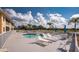 Community pool with lounge chairs and patio furniture at 26397 Nadir Rd # 208, Punta Gorda, FL 33983