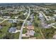 An aerial view of a residential neighborhood with various houses and landscaping at 26572 Trinilas Dr, Punta Gorda, FL 33983