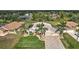Aerial view of a single-Gathering home with a large driveway and palm trees at 26572 Trinilas Dr, Punta Gorda, FL 33983