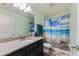 Bathroom with granite countertop, single sink, and ocean-themed shower curtain at 26572 Trinilas Dr, Punta Gorda, FL 33983