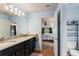 Bathroom with granite countertops, double sinks, and a view of the bedroom at 26572 Trinilas Dr, Punta Gorda, FL 33983