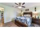 Bedroom with a wooden bed frame and ceiling fan at 26572 Trinilas Dr, Punta Gorda, FL 33983