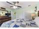 Comfortable bedroom with a patchwork quilt, dresser, and ceiling fan at 26572 Trinilas Dr, Punta Gorda, FL 33983