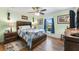 Bedroom with wooden bed frame, ceiling fan and view of backyard at 26572 Trinilas Dr, Punta Gorda, FL 33983