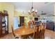 Dining room features hardwood floors and a rustic wooden table at 26572 Trinilas Dr, Punta Gorda, FL 33983
