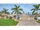 Single Gathering home exterior with a three car garage and American flag at 26572 Trinilas Dr, Punta Gorda, FL 33983