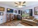 Gathering room with a sofa, desk, and built-in shelving at 26572 Trinilas Dr, Punta Gorda, FL 33983