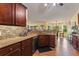 Kitchen with granite countertops, wood cabinets, and breakfast bar at 26572 Trinilas Dr, Punta Gorda, FL 33983