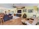 Living room with hardwood floors, comfy seating, and fireplace at 26572 Trinilas Dr, Punta Gorda, FL 33983
