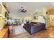 Spacious living room with hardwood floors, comfy seating, and large TV at 26572 Trinilas Dr, Punta Gorda, FL 33983