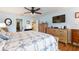 Main bedroom with king bed, dresser and en-suite bathroom at 26572 Trinilas Dr, Punta Gorda, FL 33983