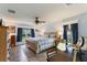 Large main bedroom with ceiling fan, wood floors and en-suite bathroom at 26572 Trinilas Dr, Punta Gorda, FL 33983