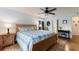 Main bedroom features a king-size bed, dresser and ceiling fan at 26572 Trinilas Dr, Punta Gorda, FL 33983