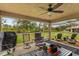 Spacious screened porch with comfortable seating and outdoor grill at 26572 Trinilas Dr, Punta Gorda, FL 33983