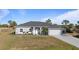 Gray house with a gray roof, white columns, and a two-car garage at 2668 Clovelon St, North Port, FL 34291