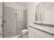 Clean bathroom, featuring a shower, granite countertop, and white cabinets at 27066 Sumatra Dr, Punta Gorda, FL 33955