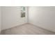 Simple bedroom with wood-look floors and a window with a view at 27066 Sumatra Dr, Punta Gorda, FL 33955