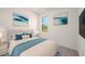 Bright bedroom with white walls, modern decor, and large window showcasing a green outdoor view at 27066 Sumatra Dr, Punta Gorda, FL 33955