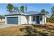 One-story home with metal roof, attached garage, and landscaped lawn at 27066 Sumatra Dr, Punta Gorda, FL 33955