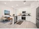 Modern kitchen with stainless steel appliances, white cabinetry, and sleek countertops at 27066 Sumatra Dr, Punta Gorda, FL 33955