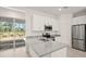 Kitchen with granite countertop island, stainless steel appliances, and access to backyard at 27066 Sumatra Dr, Punta Gorda, FL 33955
