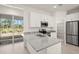 Kitchen boasts granite countertops, stainless steel appliances, and backyard access at 27066 Sumatra Dr, Punta Gorda, FL 33955