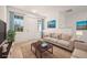 Inviting living room featuring a comfortable couch, stylish rug, and bright, airy windows at 27066 Sumatra Dr, Punta Gorda, FL 33955