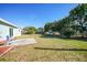 Spacious backyard with patio, grassy area, and mature trees at 27131 Ann Arbor Ave, Punta Gorda, FL 33983