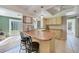 Galley kitchen with light wood cabinets and a breakfast bar at 27131 Ann Arbor Ave, Punta Gorda, FL 33983