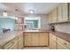 L-shaped kitchen with light-colored cabinets and butcher block countertops at 27131 Ann Arbor Ave, Punta Gorda, FL 33983