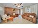 Living room featuring brown leather couches and a wood-look accent wall at 27131 Ann Arbor Ave, Punta Gorda, FL 33983