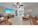 Spacious living area with large TV, comfortable seating, and an open floor plan at 27131 Ann Arbor Ave, Punta Gorda, FL 33983