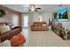 Living room with two brown leather couches and a large flat screen TV at 27131 Ann Arbor Ave, Punta Gorda, FL 33983