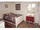 Bedroom with white bed frame and patriotic bedding at 273 Mark Twain Ln, Rotonda West, FL 33947