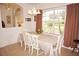 Dining area with white table and chairs, and large window at 273 Mark Twain Ln, Rotonda West, FL 33947