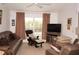 Relaxing living room featuring leather furniture and a pool view at 273 Mark Twain Ln, Rotonda West, FL 33947