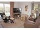 Relaxing living room with leather furniture, TV, and pool view at 273 Mark Twain Ln, Rotonda West, FL 33947