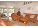 Living room with leather furniture and access to the pool at 273 Mark Twain Ln, Rotonda West, FL 33947